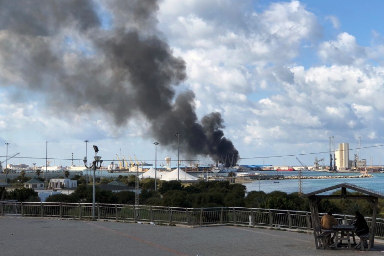 Smoke rises from a port of Tripoli after being attacked in Tripoli