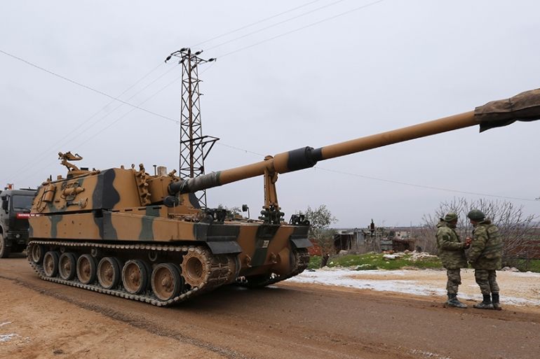 Turkish military convoy is seen near the town of Idlib, Syria, Wednesday, Feb. 12, 2020. Turkish President Recep Tayyip Erdogan said Wednesday that Turkey will attack government forces anywhere in Syr