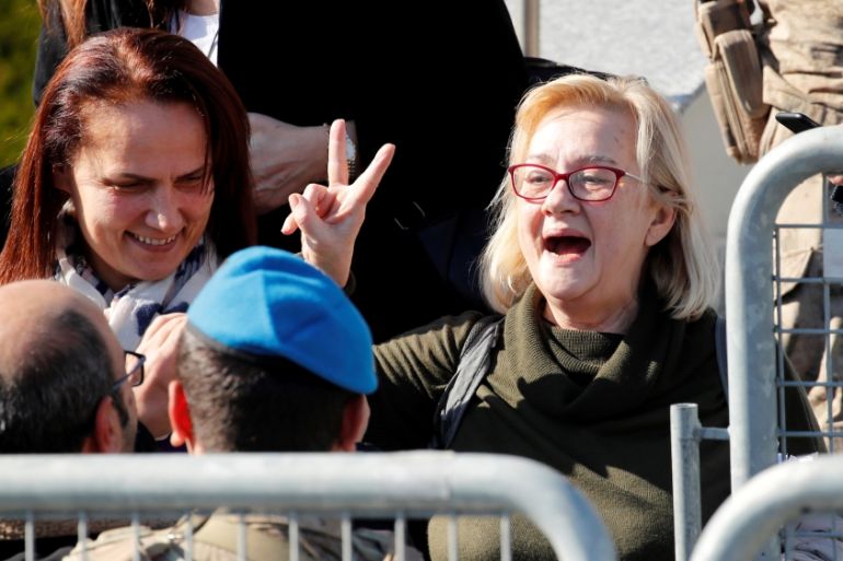 Mucella Yapici, who is one of the 16 defendants acquitted over their alleged role in Turkey''s Gezi Park protests case, gestures after leaving a courtroom at the Silivri Prison and Courthouse complex