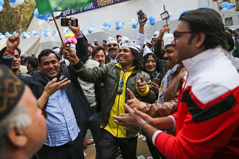 Supporters of the Aam Aadmi Party, or "common man''s" party, celebrate as initial results show the party in the lead, at their party office in New Delhi, India, Tuesday, Feb. 11, 2020. The polls put I