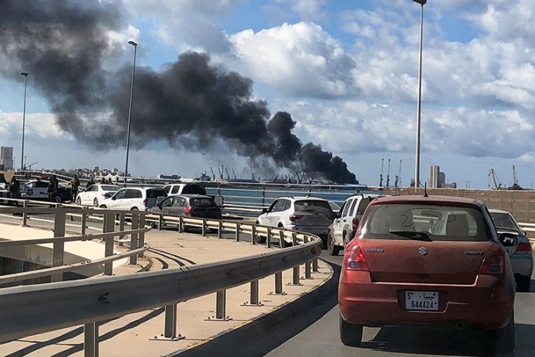 A smoke rises from a port of Tripoli after being attacked in Tripoli, Libya February 18, 2020. REUTERS/Ahmed Elumami