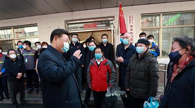 In this photo released by Xinhua News Agency, Chinese President Xi Jinping wearing a protective face mask speaks to residents as he inspects the novel coronavirus pneumonia prevention and control work