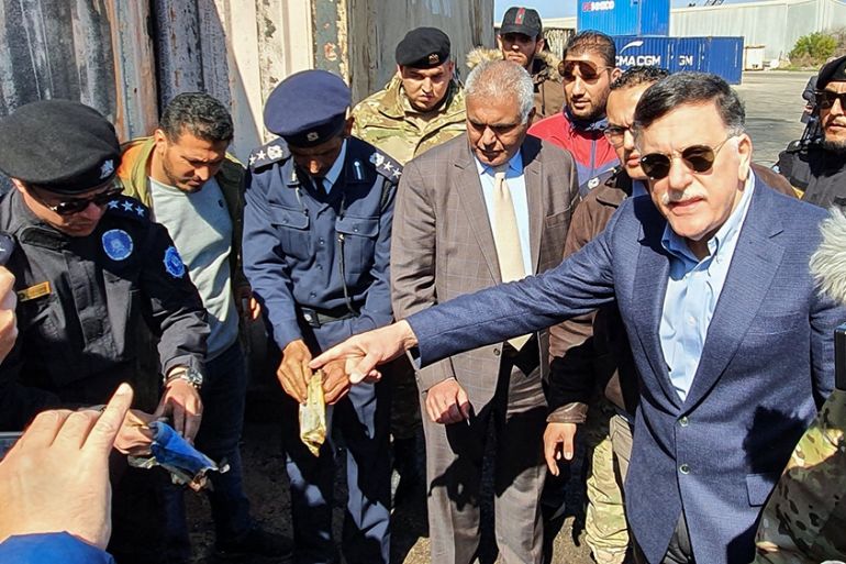Prime Minister of Libya''s UN-recognised Government of National Accord (GNA) Fayez al-Sarraj, flanked by journalists, visits the port in the capital Tripoli after it was hit by rocket fire on February