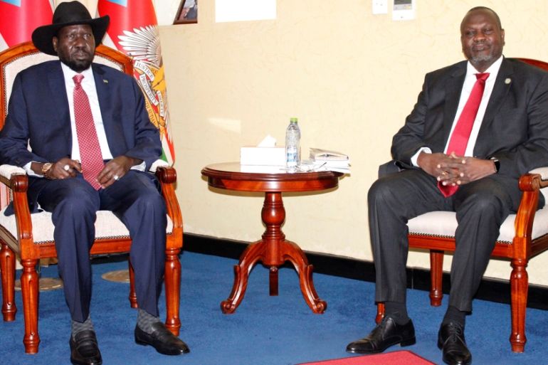 South Sudan''s President Salva Kiir Mayardit(L) and former vice president and rebel leader Riek Machar pose for pictures before their meeting in which they have reached a deal to form a long-delayed un