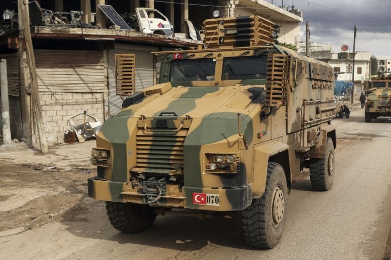 Turkish military convoy drives through the village of Binnish, in Idlib province, Syria, Saturday, Feb. 8, 2020. Several Turkish armored vehicles and tanks entered rebel-controlled northwestern Syria