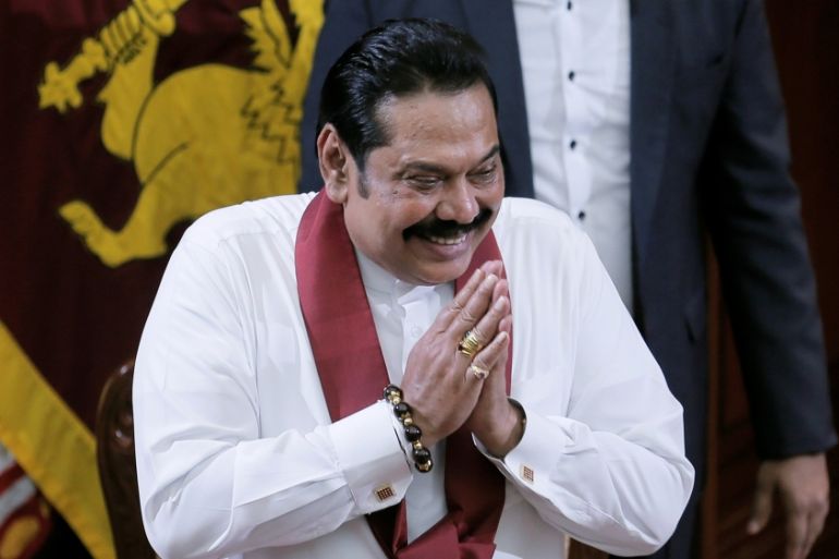 Sri Lanka''s former leader Mahinda Rajapaksa, who was appointed as the new Prime Minister, gestures during the swearing in ceremony in Colombo