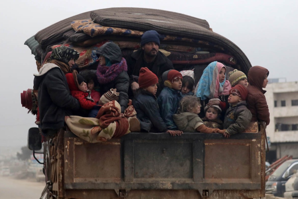 Internally displaced Syrians from western Aleppo countryside, ride on the back of a truck with belongings in Hazano near Idlib, Syria, February 11, 2020. REUTERS/Khalil Ashawi
