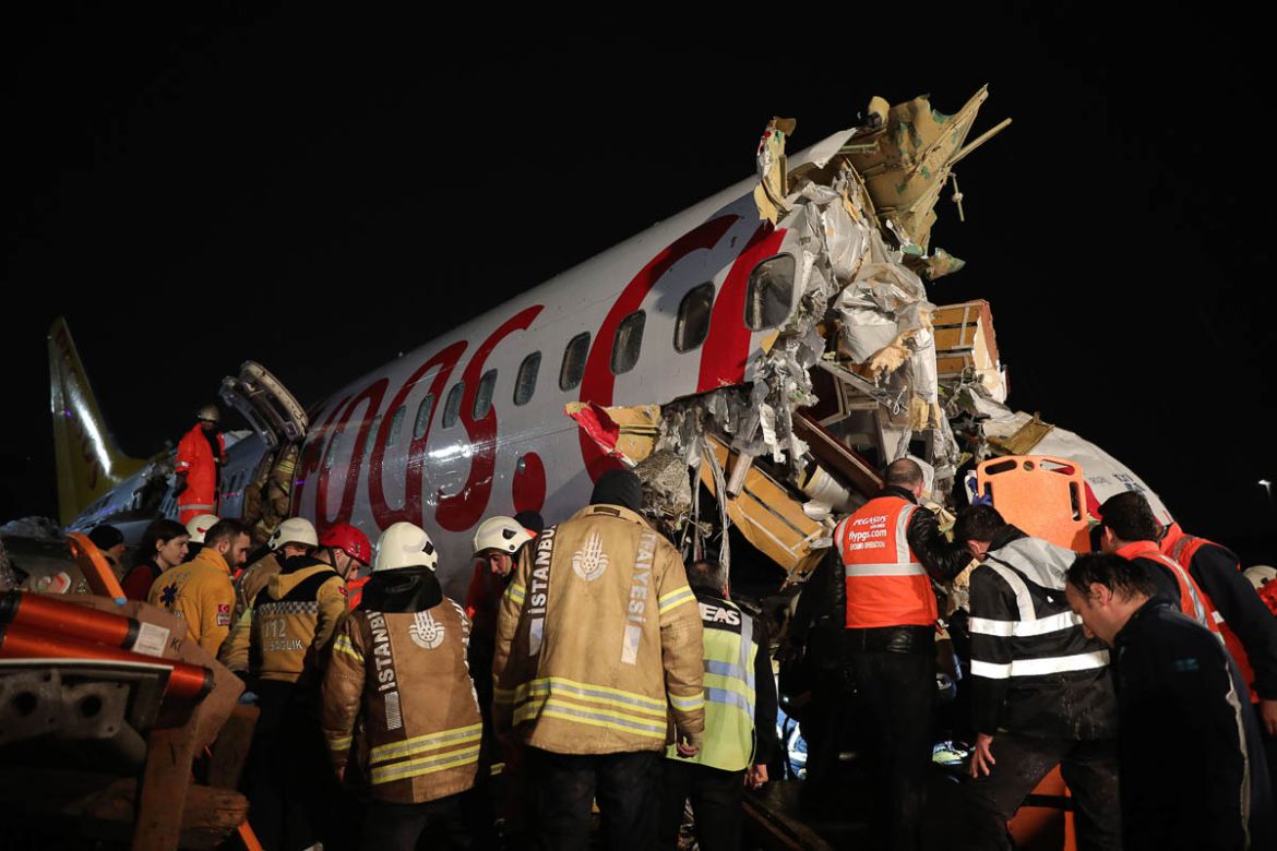 Rescue members and firefighters work after a plane skidded off the runway at Istanbul''s Sabiha Gokcen Airport, Istanbul, Wednesday, Feb. 5, 2020. A plane skidded off the runway Wednesday at Istanbul’s
