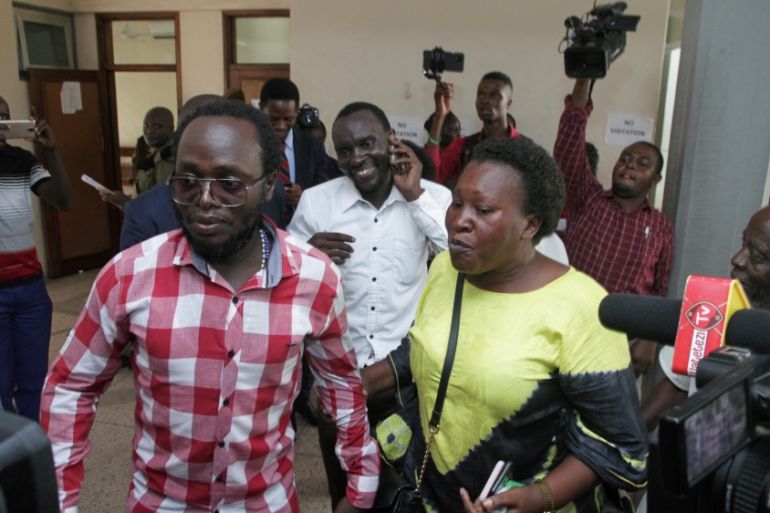 Tanzanian investigative journalist Erick Kabendera is escorted as he is freed after pleading guilty to financial crimes, at the Kisutu Residents Magistrate Court in Dar es Salaam