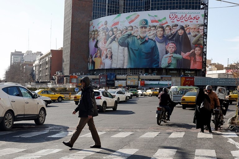 epa08213129 Iranians walk on a street in Tehran, Iran, 12 February 2020. Iranian candidates for the parliamentary elections will begin campaigns from 13 February for elections scheduled on 21 February