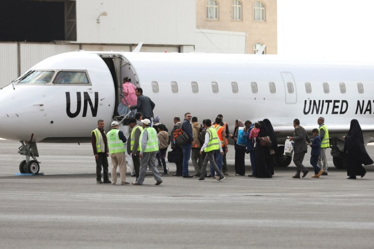 People board a United Nations plane which will carry them to Amman, Jordan from Sanaa airport Yemen