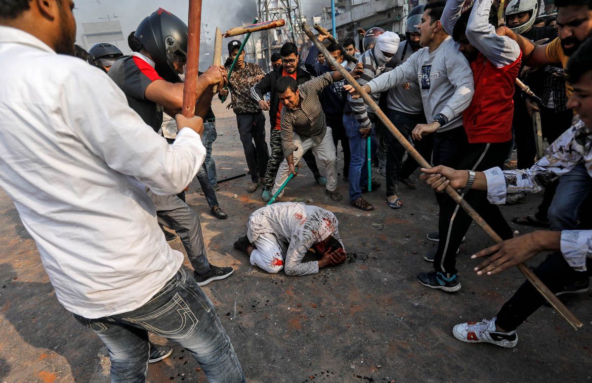 People supporting the new citizenship law beat a Muslim man during a clash with those opposing the law in New Delhi, India, February 24, 2020. REUTERS/Danish Siddiqui