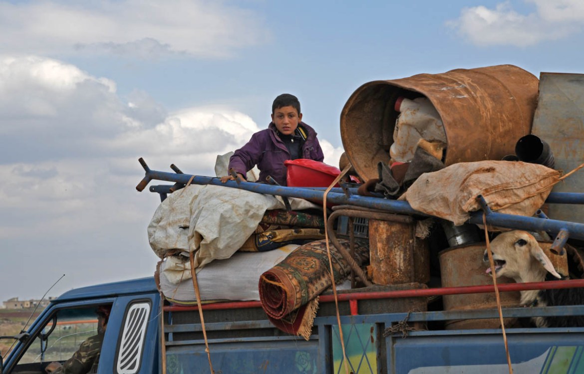 A truck loaded with a family''s belongings drives on the outskirts of the town of Deir Ballut as Syrians fleeing attacks by pro-regime forces on rebel-held areas in the Aleppo and Idlib provinces head