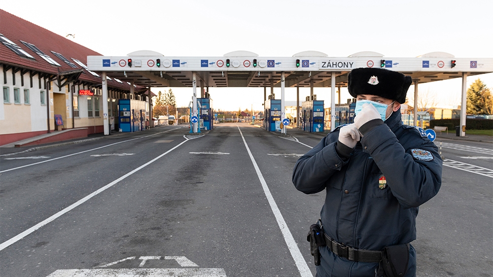 epa08295360 A Hungarian policeman wears a protictive face mask at the border crossing into Ukraine in Zahony, northeastern Hungary, 15 March 2020. The Ukrainian authorities have closed their county bo