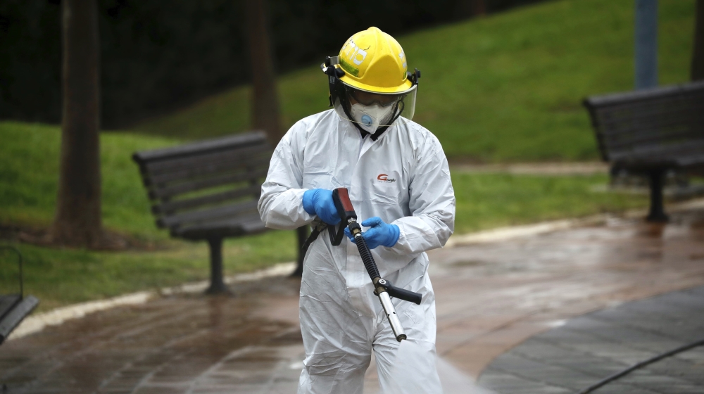 An Israeli firefighter sprays disinfectant as a precaution against the coronavirus in Modi'in, Israel, Tuesday, March 17, 2020. The head of Israel's shadowy Shin Bet internal security service said Tue