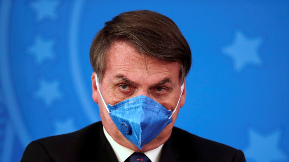 Brazil's President Jair Bolsonaro is pictured with his protective face mask at a press statement during the coronavirus disease (COVID-19) outbreak in Brasilia