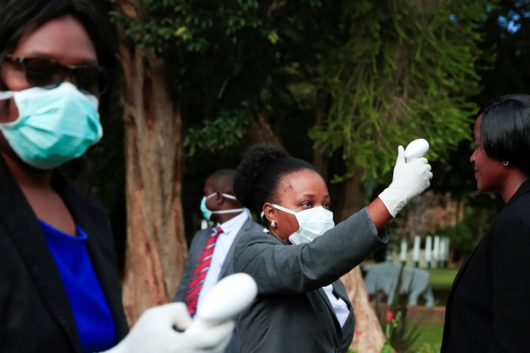 Health workers screen visitors to prevent the spread of coronavirus disease (COVID-19) at State House in Harare