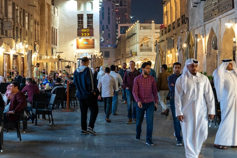 People walk in Souq Waqif, Doha, Qatar on March 06, 2020 [Sorin Furcoi/Al Jazeera]