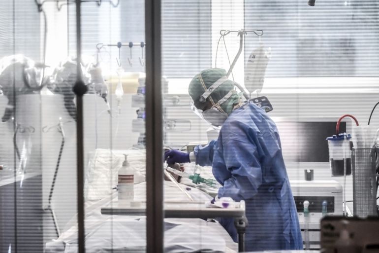 Medical personnel at work in the intensive care unit of the hospital of Brescia, Italy, Thursday, March 19, 2020. Italy has become the country with the most coronavirus-related deaths, surpassing Chin