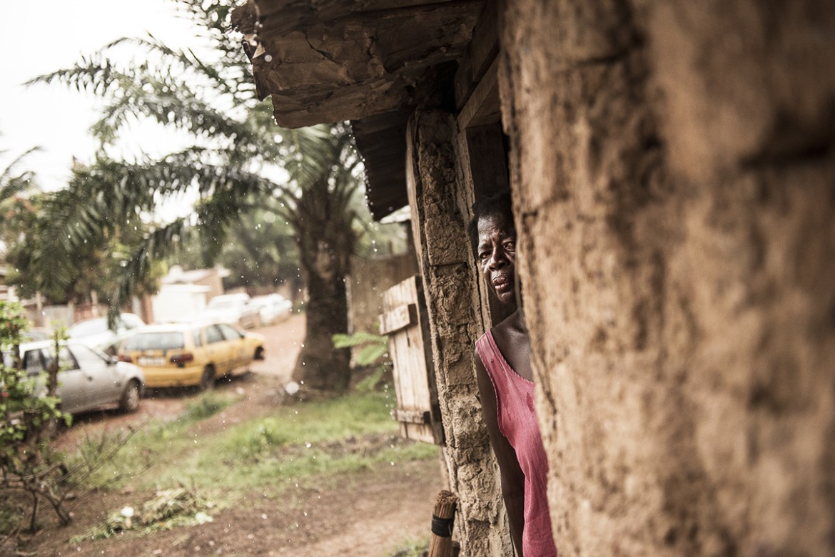 Martine Rengapou looking outside her house in Bangui. She is constantly victim of harassment and attacks by young people of the neighborhood. She tells the accusation of witchcraft is an indelible sta