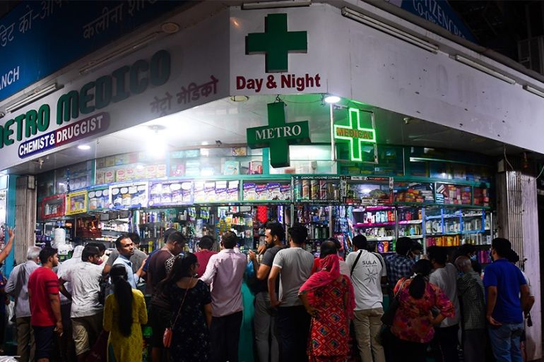People gather at a pharmacy to buy supplies following Indian Prime Minister''s announcement of a government-imposed nationwide lockdown as a preventive measure against the COVID-19 coronavirus in Mumba