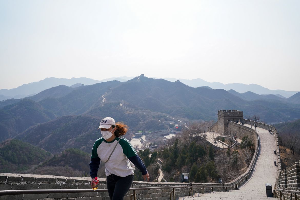 BEIJING, CHINA - MARCH 24: A Chinese tourist wears a protective mask as she visit the almost empty Badaling Great Wall on March 24, 2020 in Beijing, China. Affected by the new coronavirus covid-19, t