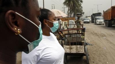 Local residents wear protective face masks on the streets of Lagos, Nigeria, on Friday, Feb. 28, 2020. Nigerian health authorities said they’re tracing everyone who’s been in contact with an Italian m