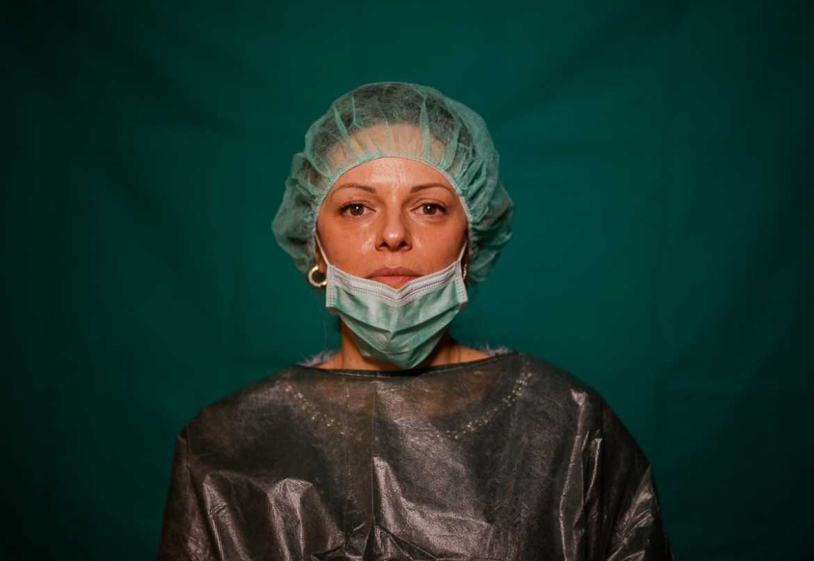Laura Orsini, 39, an administrative worker at Rome''s COVID 3 Spoke Casalpalocco Clinic poses for a portrait, Friday, March 27, 2020, during a break in her daily shift. The intensive care doctors and n