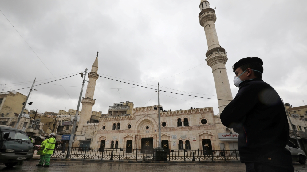 A Jordanian policeman stands guard in front of al Husseini mosque building after closing it to the worshipers amid concerns over the coronavirus disease (COVID-19) spread, in downtown Amman