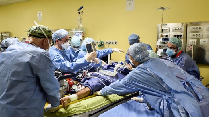 Members of the medical staff in protective suits treat a patient suffering from coronavirus disease (COVID-19) in an intensive care unit at the San Raffaele hospital in Milan, Italy, March 27, 2020. R