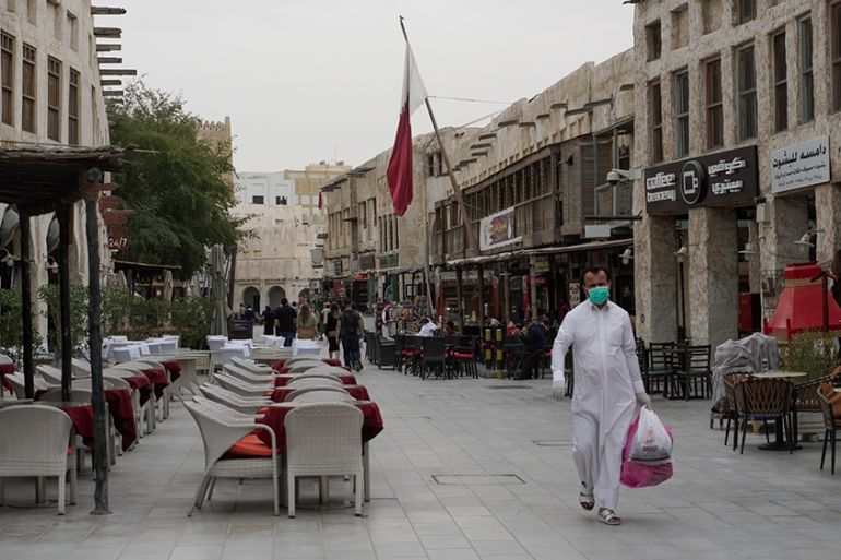 People wearing protective masks in Souq Waqif as the number of coronavirus cases has increased by 17 on, Doha, Qatar, Saturday, March 14, 2020 [Sorin Furcoi/Al Jazeera]