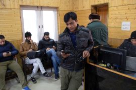 In this Jan. 30, 2020, photo, Kashmiri journalists browse the internet on their mobile phones inside the media center set up by government authorities in Srinagar, Indian controlled Kashmir. Six month
