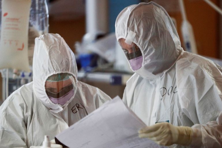Medical workers in protective suits treat patients suffering with coronavirus disease (COVID-19) in Rome