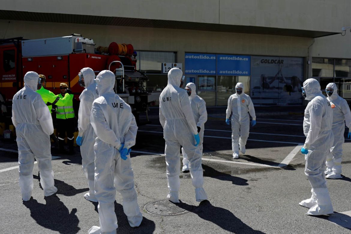 Members of the Military Emergency Unit (UME) prepare to disinfect the Malaga-Costa del Sol international airport during partial lockdown as part of a 15-day state of emergency to combat the coronaviru