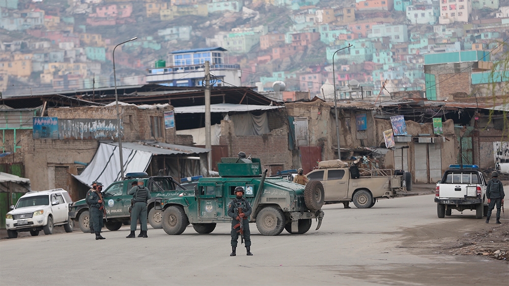 Afghan police arrive at the site of an attack in Kabul, Afghanistan, Wednesday, March 25, 2020. Gunmen stormed a religious gathering of Afghanistan's minority Sikhs in their place of worship in the he