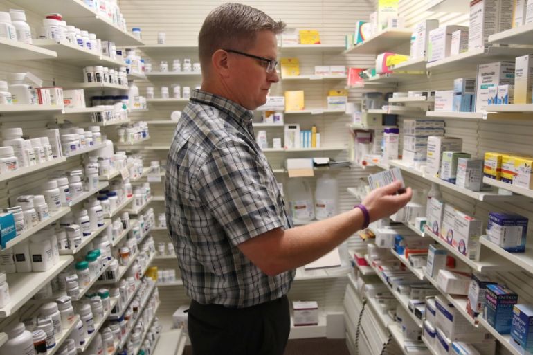 Pharmacist Thomas Jensen, looks over a prescription drug at the Rock Canyon pharmacy in Provo, Utah