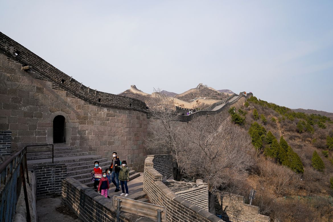 BEIJING, CHINA - MARCH 24: A chinese family wearing a protective masks as they visit the almost empty Badaling Great Wall on March 24, 2020 in Beijing, China. Affected by the new coronavirus covid-1