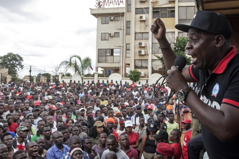 Executive Director at the Centre for Human Rights and Rehabilitation Timothy Mtambo (R) addresses protesters in Lilongwe on January 16, 2020, during a protest to denounce alleged