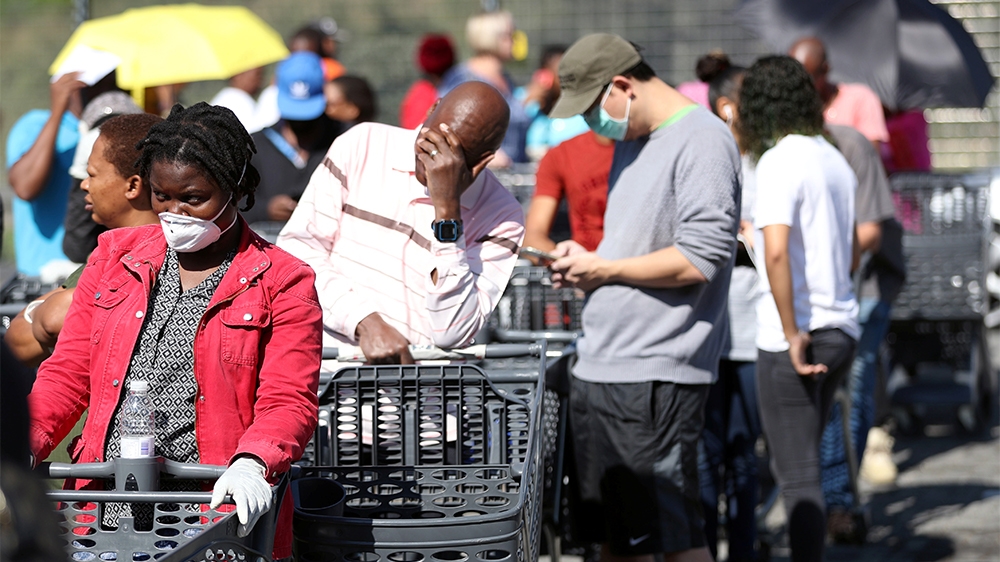 Shoppers queue to stock up on groceries at a Pick n Pay store during a nationwide lockdown of 21 days to try to contain the coronavirus disease (COVID-19) outbreak, in Johannesburg, South Africa, Marc
