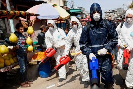 Workers wearing protective gear spray disinfectant as a precaution against the coronavirus, at the main market in Gaza City, Thursday, March 19, 2020. The Middle East has some 20,000 cases of the viru