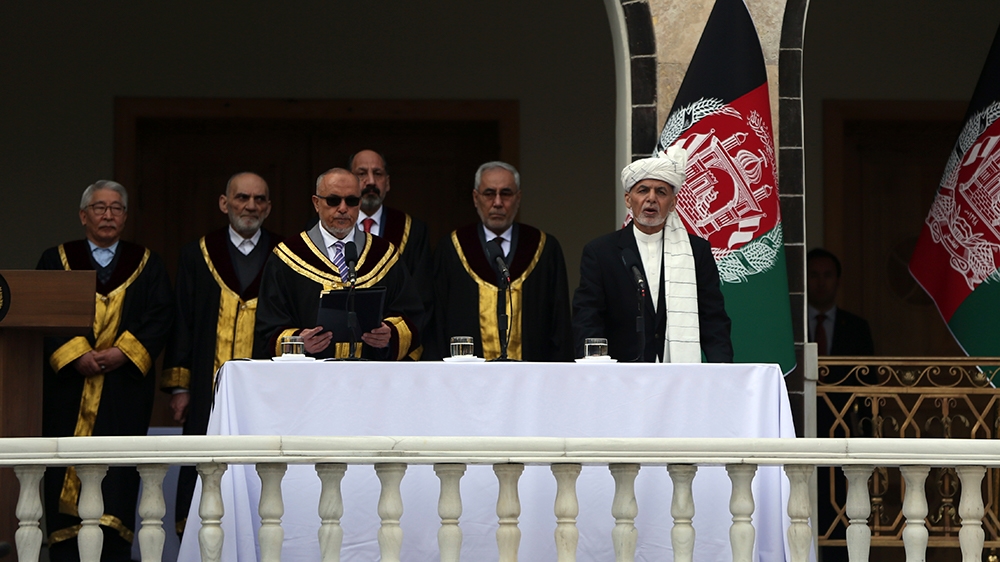 Afghan President Ashraf Ghani, right, is sworn in by Chief Justice Sayed Yousuf Halim, during his inauguration ceremony at the presidential palace in Kabul, Afghanistan, Monday, March 9, 2020. (AP Pho