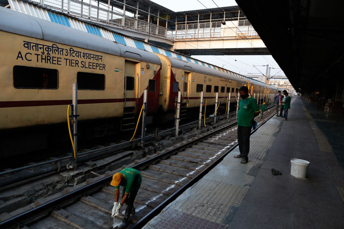 An Indian railway worker sprays disinfectants as a precautionary measure against COVID-19 in Prayagraj, India, Tuesday, March 24, 2020. Indian Prime Minister Narendra Modi Tuesday announced a total lo