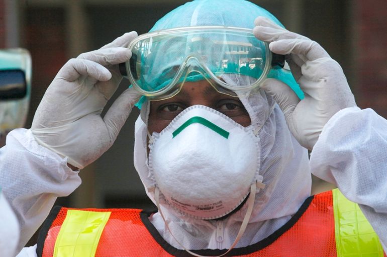 A Pakistani health personnel takes part in a drill exercise as a preventative measures during an emergency of coronavirus outbreak, in Peshawar Pakistan, Monday, March 3, 2020. Pakistani health offici