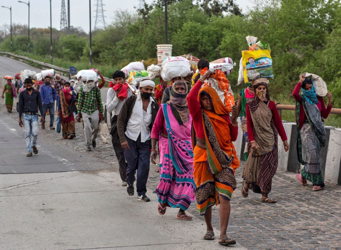 Migrant workers walk along a road to return to their villages, during a 21-day nationwide lockdown to limit the spreading of coronavirus disease (COVID-19), in New Delhi, India, March 26, 2020. REUTER