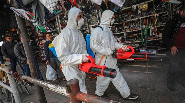 epa08306457 Palestinians spray disinfectant as a precaution against the spread of the Covid-19 coronavirus, in Gaza City, 19 March 2020. Countries around the world are taking increased measures to ste