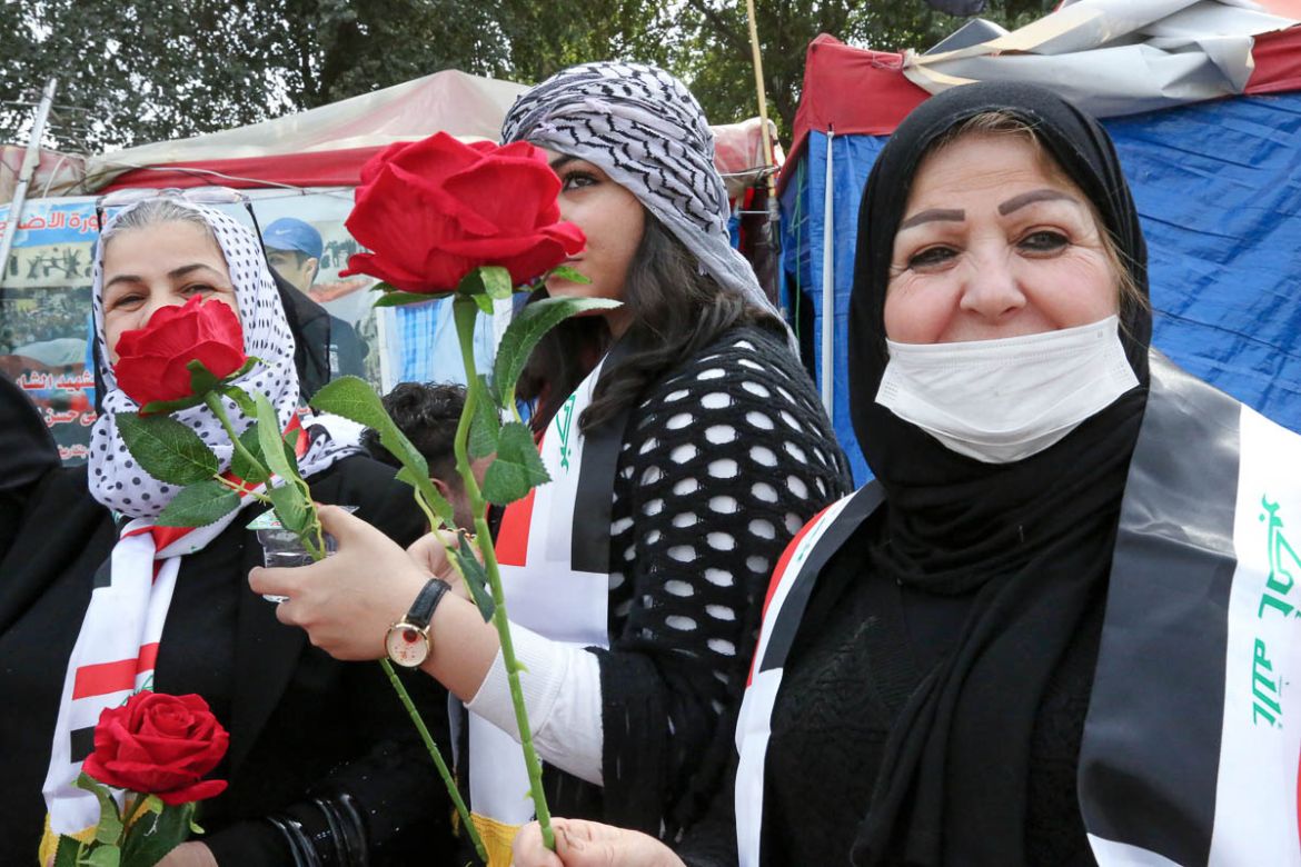 Iraqi women, including one wearing a protective mask due to the novel coronavirus epidemic, celebrate International Women''s Day at Tahrir Square in the Iraqi capital Baghdad, on March 8, 2020. (Photo