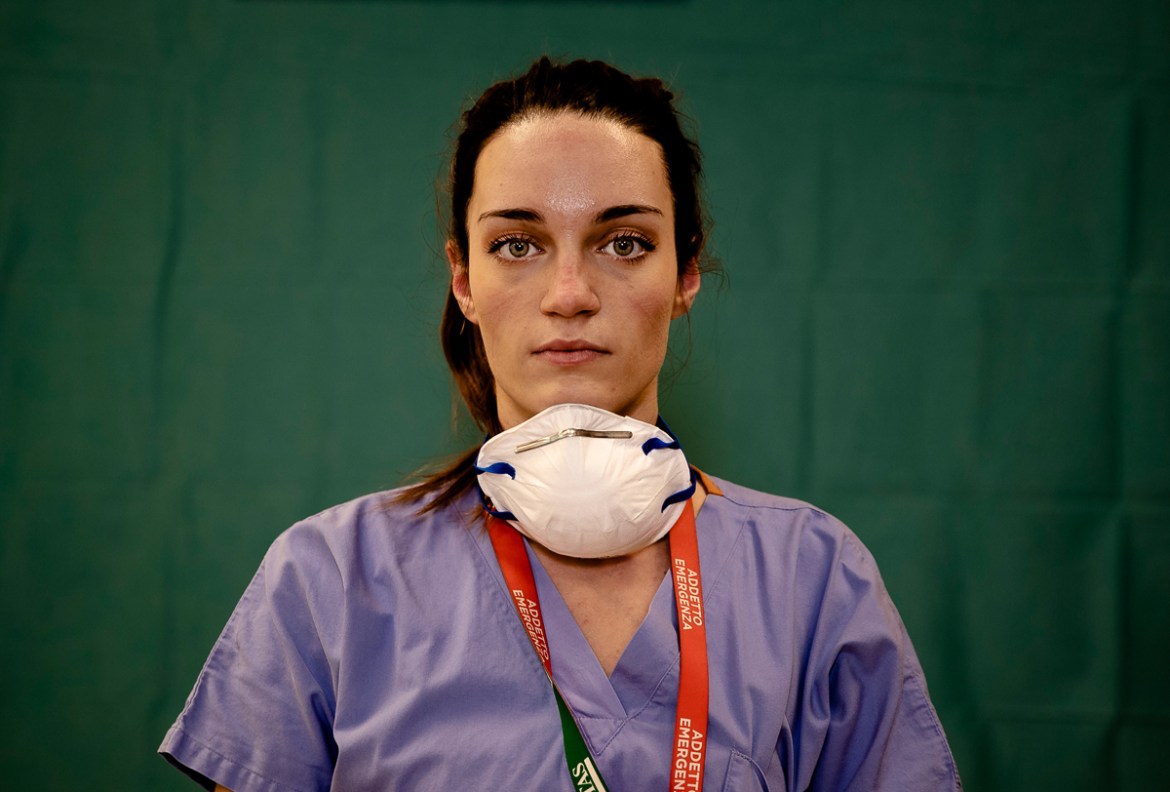 Martina Papponetti, 25, a nurse at the Humanitas Gavazzeni Hospital in Bergamo, Italy poses for a portrait at the end of her shift Friday, March 27, 2020. Their eyes are tired. Their cheekbones rubbed