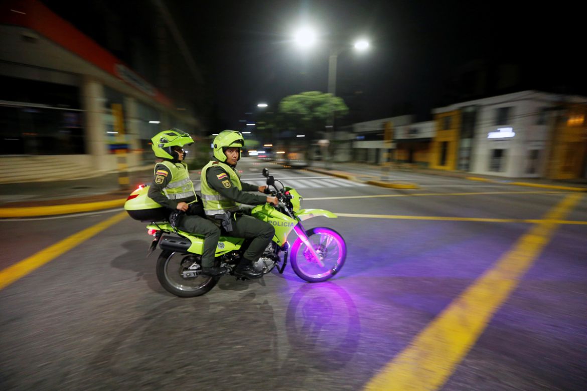 Police officers patrol an empty street on a motorcycle, after a curfew was imposed by the mayor''s office as preventive measure against the spread of the coronavirus disease (COVID-19), in Bucaramanga,