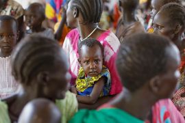 epa07742390 A young South Sudanese refugee boy is held by his mother as the await for their turn during a health checkup in Kakuma Refugee Camp, Turkana county, northern Kenya, 25 June 2019. Despite a