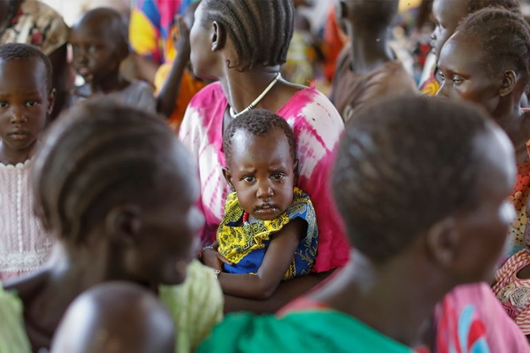 epa07742390 A young South Sudanese refugee boy is held by his mother as the await for their turn during a health checkup in Kakuma Refugee Camp, Turkana county, northern Kenya, 25 June 2019. Despite a